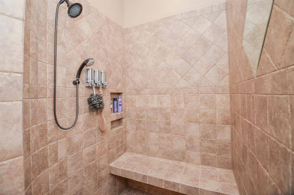 Shower within the secondary primary bathroom downstairs.