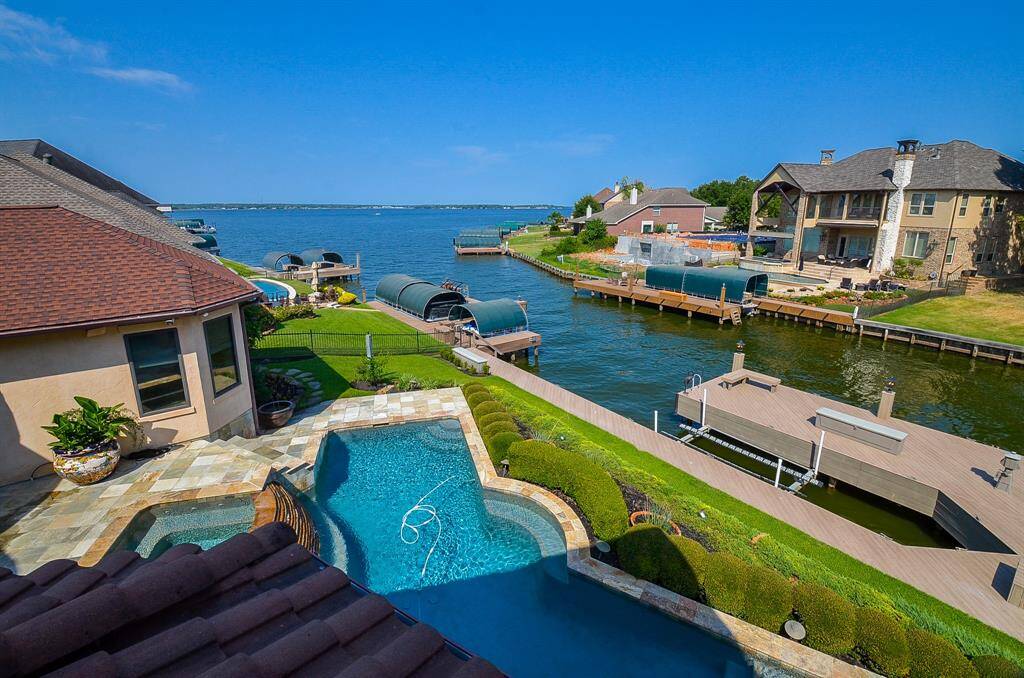 Nestled at the mouth of a sheltered cove, this location offers the best of both worlds with its expansive views of Lake Conroe and protection from the elements.  To the right is a shows one of the two boat slips.  One is covered and one is not.  Both are motorized.  Not pictured is also two motorized jet ski lifts and three dry boxes for additional storage.