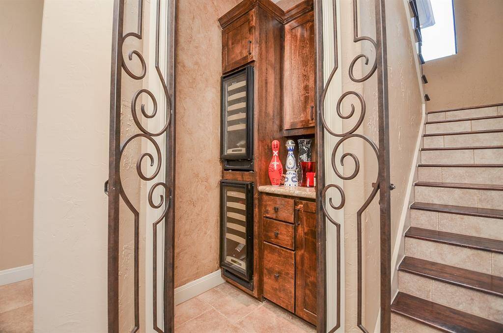The wine room features dual coolers, providing the perfect conditions for storing red and white wines, as well as any liquor you may have.