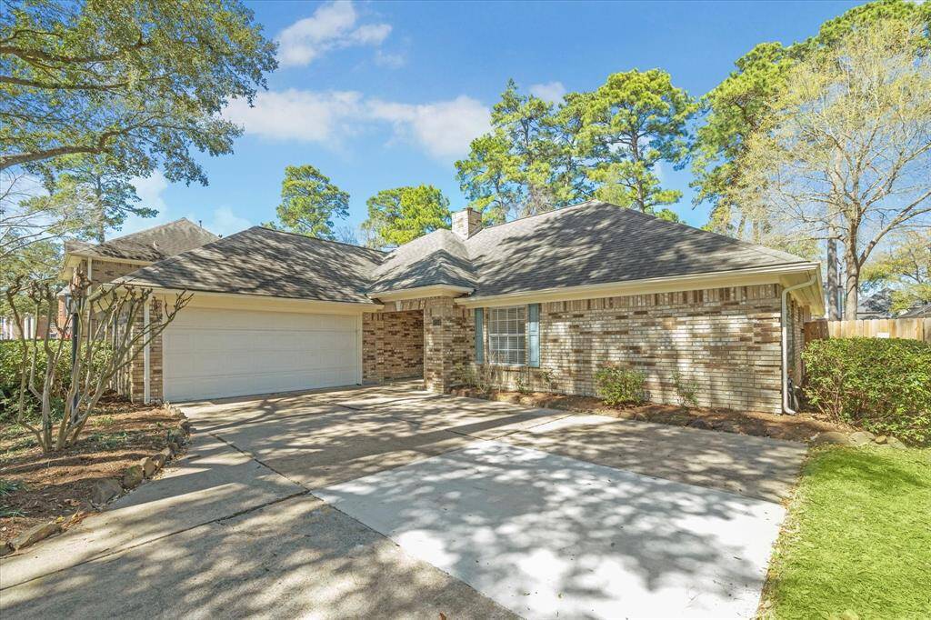 Charming single-story home with a brick exterior, spacious driveway, and attached two-car garage. Surrounded by mature trees, it offers a serene and inviting atmosphere.