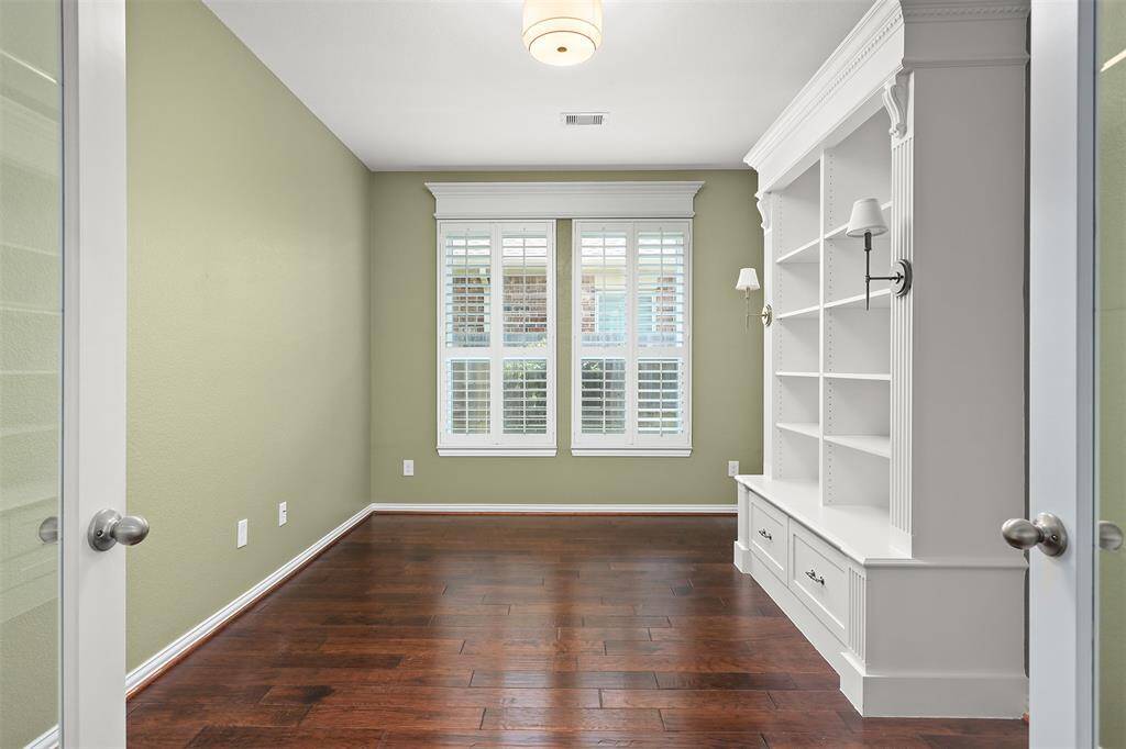 Custom built-ins with trendy sconces and plantation shutters