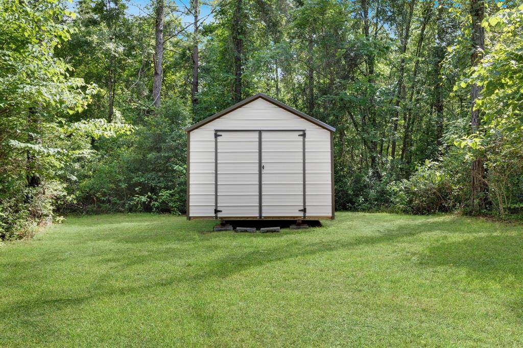 Convenient storage shed for tools, equipment, or extra supplies located near the west cabin.