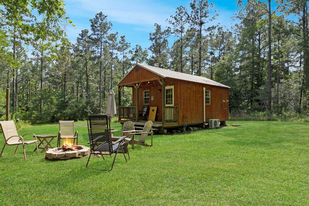 Relax and unwind at the outdoor fire pit area, complete with seating and hammocks. Perfect for gathering under the stars or a friendly game of corn hole.