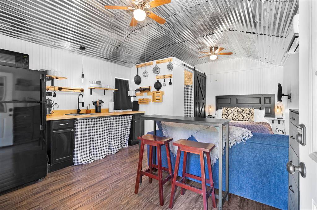 Light filled cabin interior with finished electric, mini split AC/heat, and rustic charm.