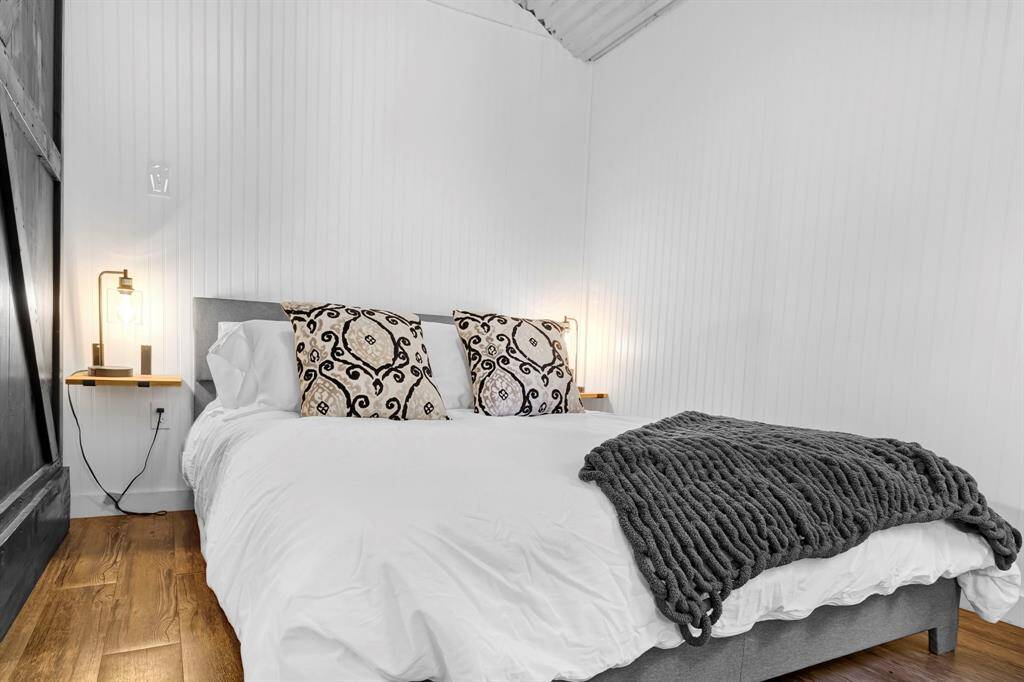 Comfortable sleeping space with with built in tables and a TV on an adjustable mount to watch from bed or the couch.