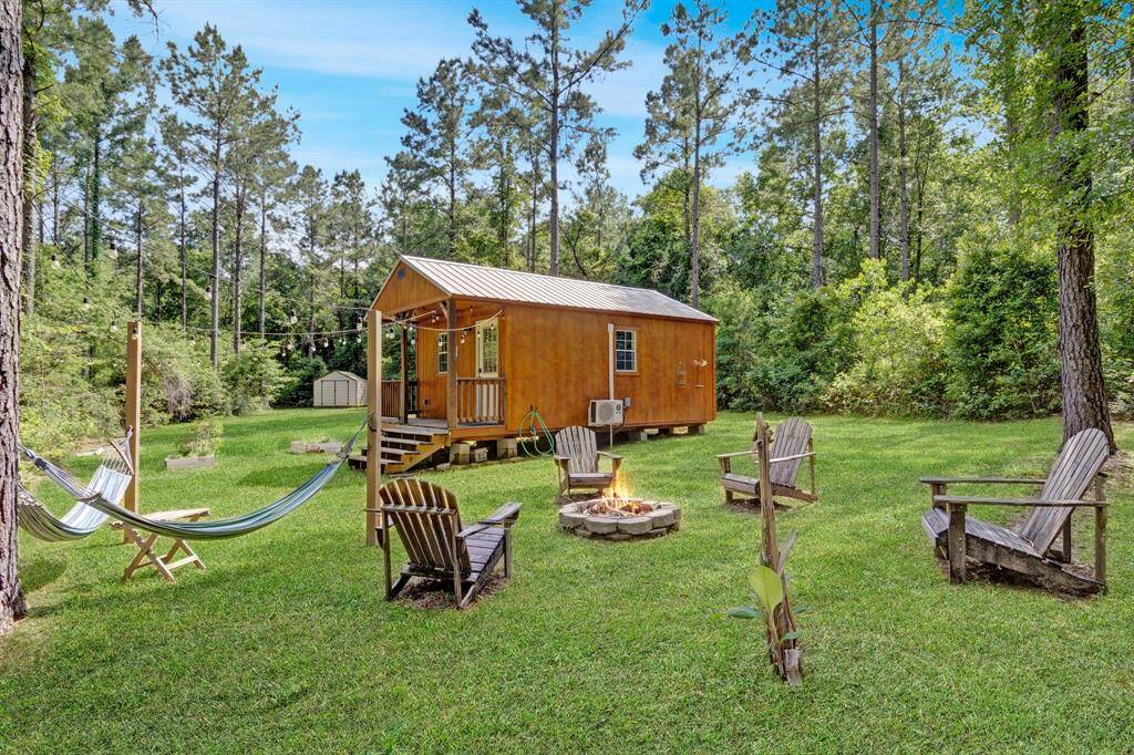 Relax and unwind in the outdoor fire pit area, complete with seating and hammocks. Perfect for gathering under the stars.