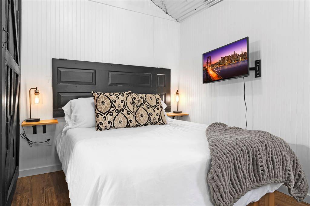 Comfortable sleeping space with with built in tables and a TV on an adjustable mount to watch from bed or the couch.