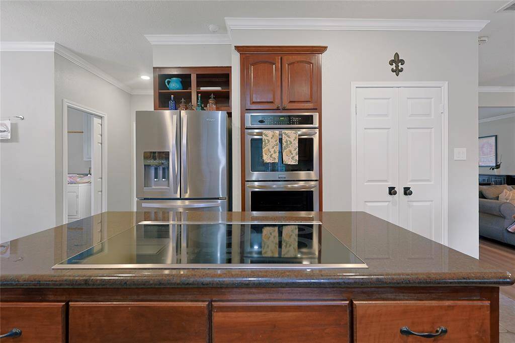 The kitchen features wood cabinets,creating a clean and timelessaesthetic.