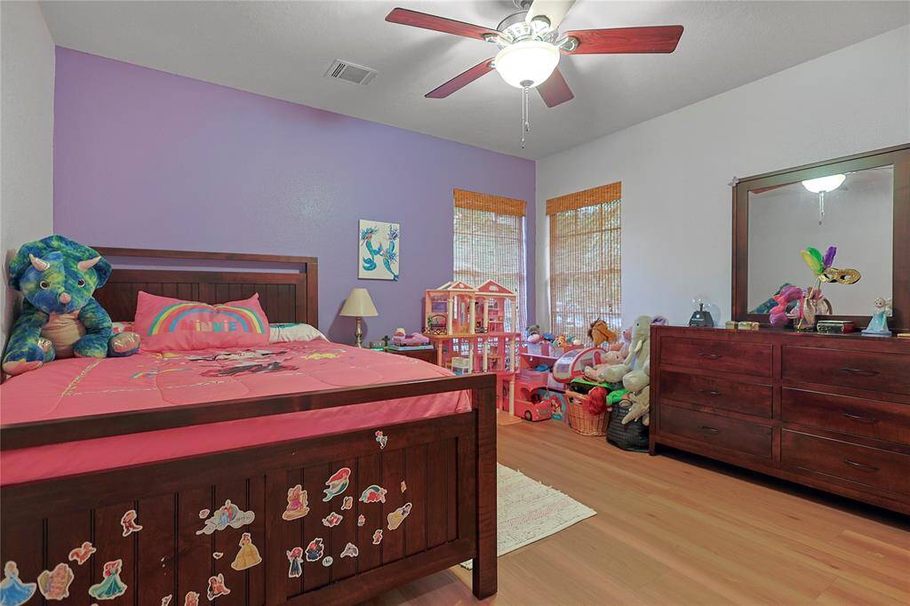 Third bedroom features largewindows, custom paint, and a ceilingfan.
