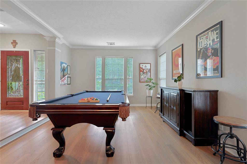 This dining room currently beingused as a game room is bathed innatural light streaming throughexpansive windows.
