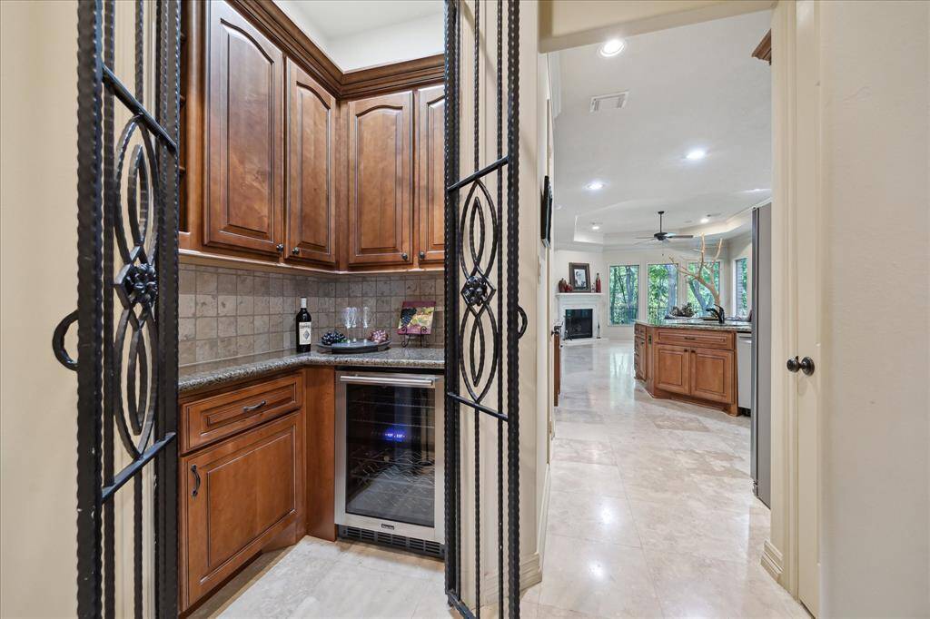 A cozy grotto with dual-zone wine fridge adds an elegant touch.