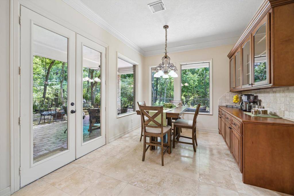 The inviting breakfast room is filled with natural light and ideally positioned off the kitchen for everyday dining.