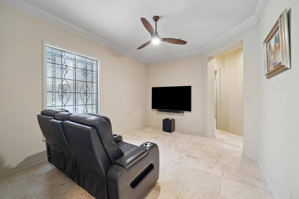 The formal dining room offers versatile space and is currently being used as a media room, showcasing the home’s flexible layout.