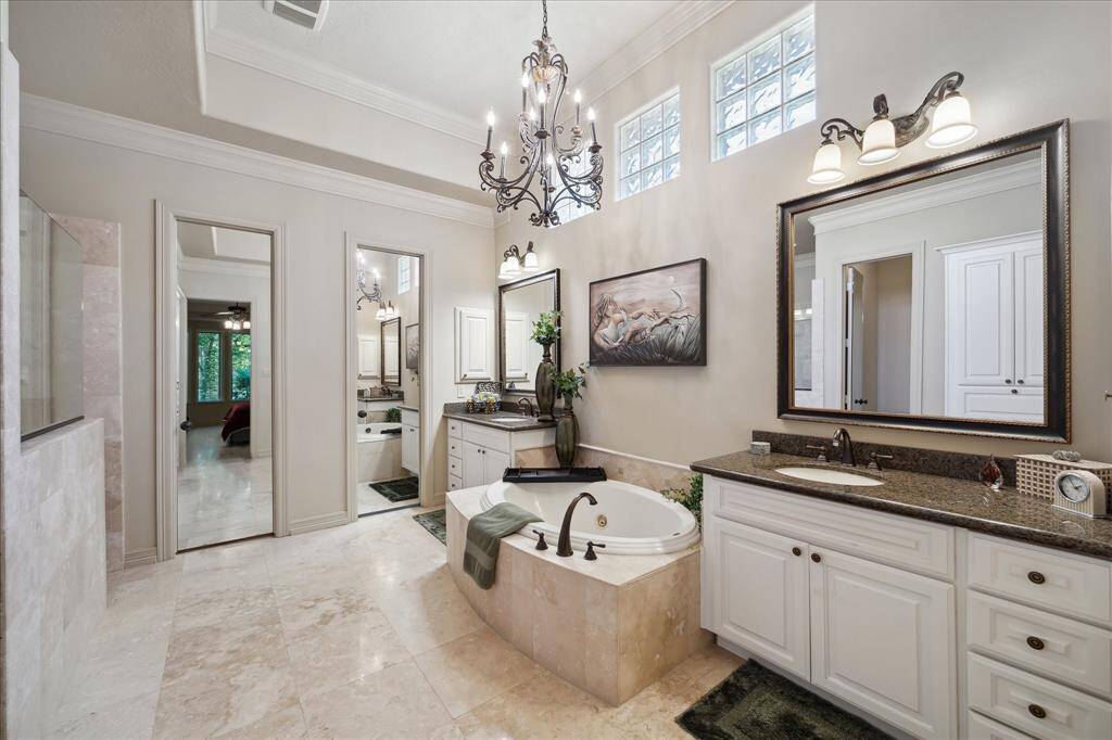 The oversized primary bathroom offers a true spa-like retreat, featuring a luxurious jacuzzi tub perfect for soaking.