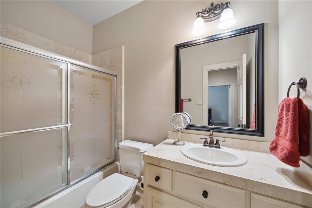 The secondary bathroom upstairs features a tub-shower combo and vanity perfect for guests.
