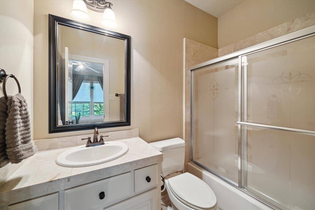 Perfect for guests or family members seeking extra privacy, the bathroom is well-appointed with a tub-shower combo and vanity, providing comfort and functionality.