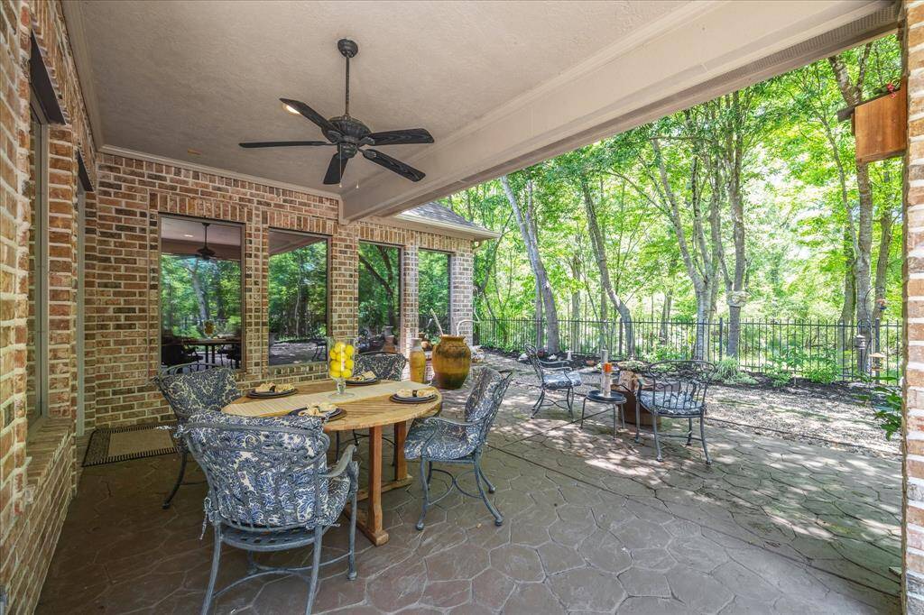 Enjoy a peaceful lunch or morning coffee on the covered patio, surrounded by lush greenery and the natural beauty that envelops this home.