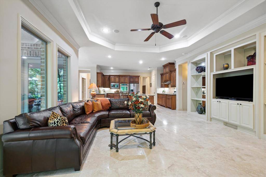 Set beneath a beautifully crafted coffered ceiling, the shelving adds balance to the room.
