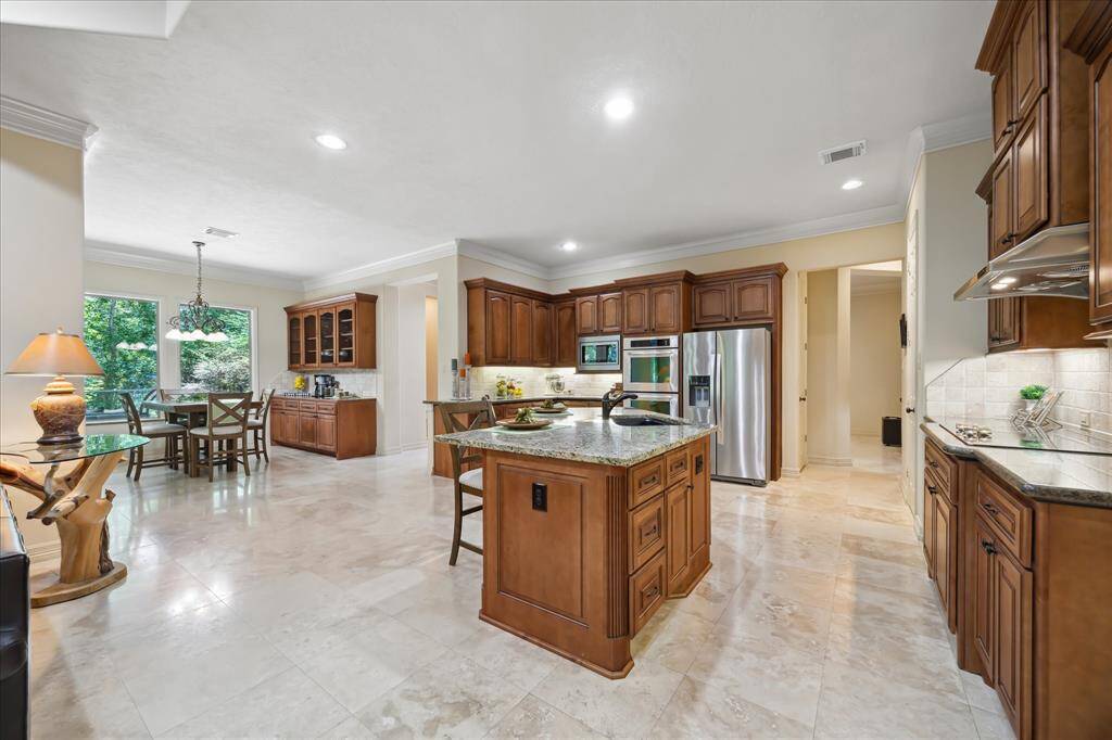 This spacious, gourmet kitchen features a large breakfast bar island perfect for casual dining and gathering.