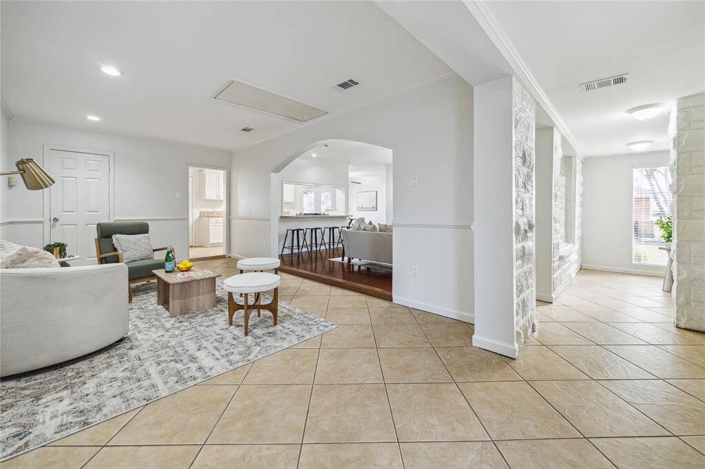 The entry is light and bright, showcasing the inviting feel of the home. The tucked away area to the right is the perfect spot for a mudroom.