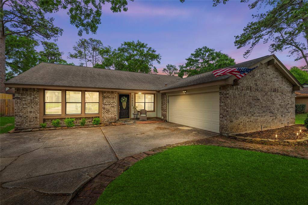 Charming single-story brick home with a cozy front porch, spacious driveway, and attached two-car garage. The well-maintained yard features lush greenery and mature trees, creating an inviting home!