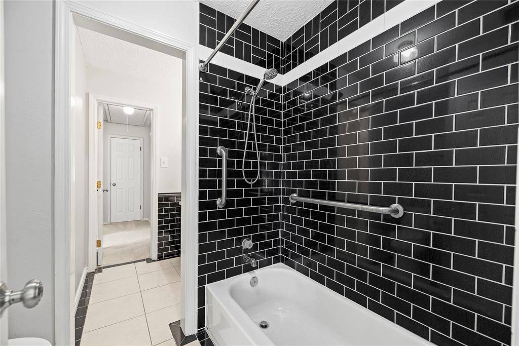 Beautiful subway tile continued into the shower area.
