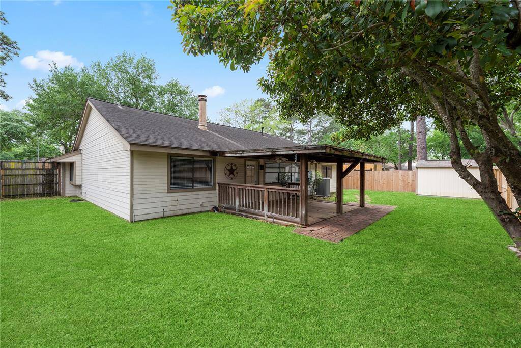 A great sized backyard that has a covered porch, mature trees and a storage shed.