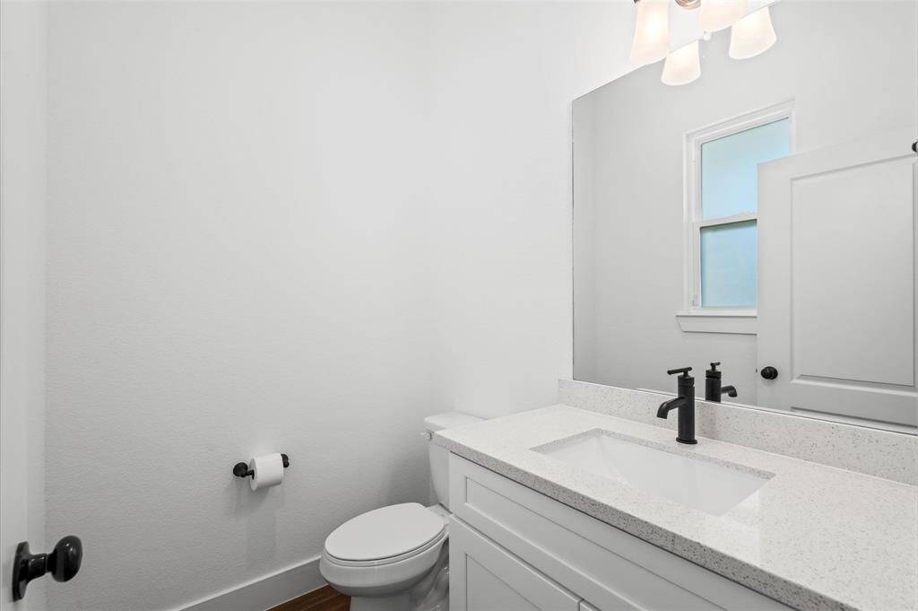 Natural light, quartz countertops and modern hardware decorate the guest bath downstairs beautifully!