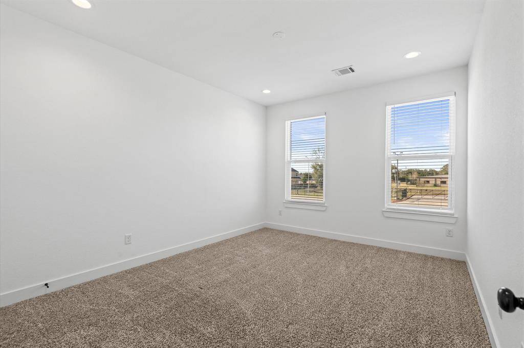 View into one of the two secondary bedrooms housed upstairs.
