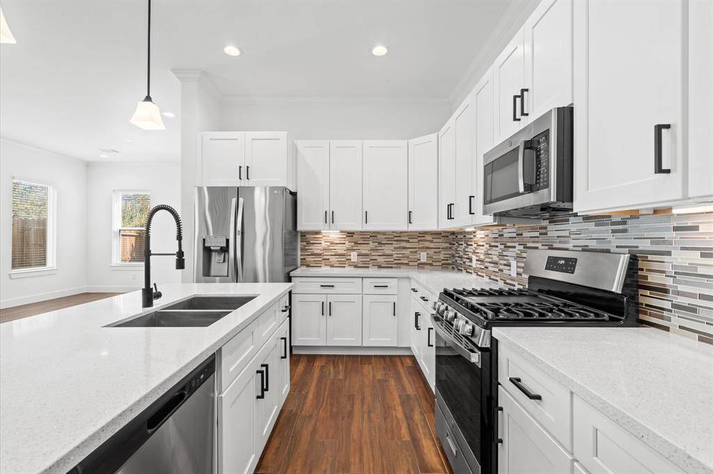 Stainless steel appliances and soft-close drawers & cabinets add to the utility aspect of this gorgeous kitchen. The standard depth refrigerator is ready to hold all of your essentials to keep you nourished, and setting intentions for the new year!