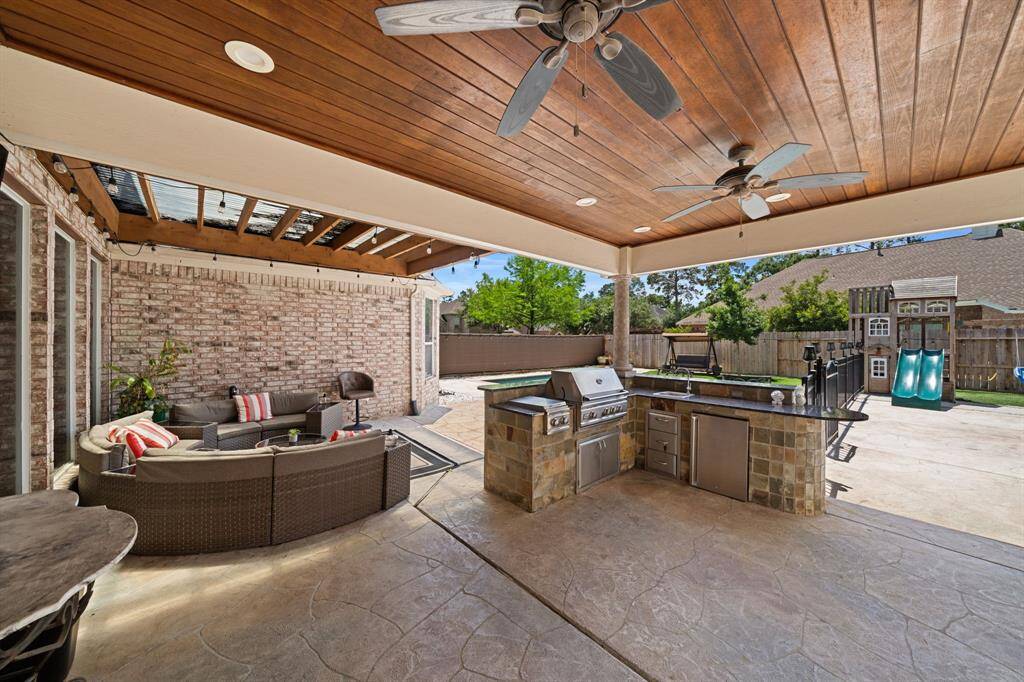 This is the perfect home for outdoor entertaining! Large covered area with tongue-in-groove wood ceiling, seating area, and outdoor kitchen.