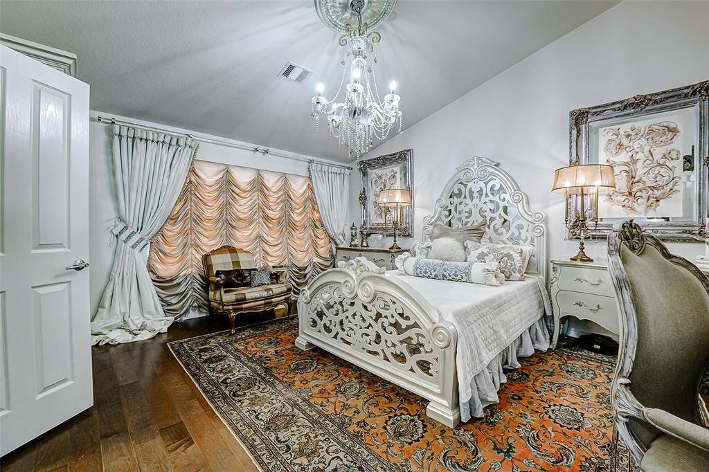 Tucked down the hallway is the serene primary bedroom, designed for comfort and retreat.
