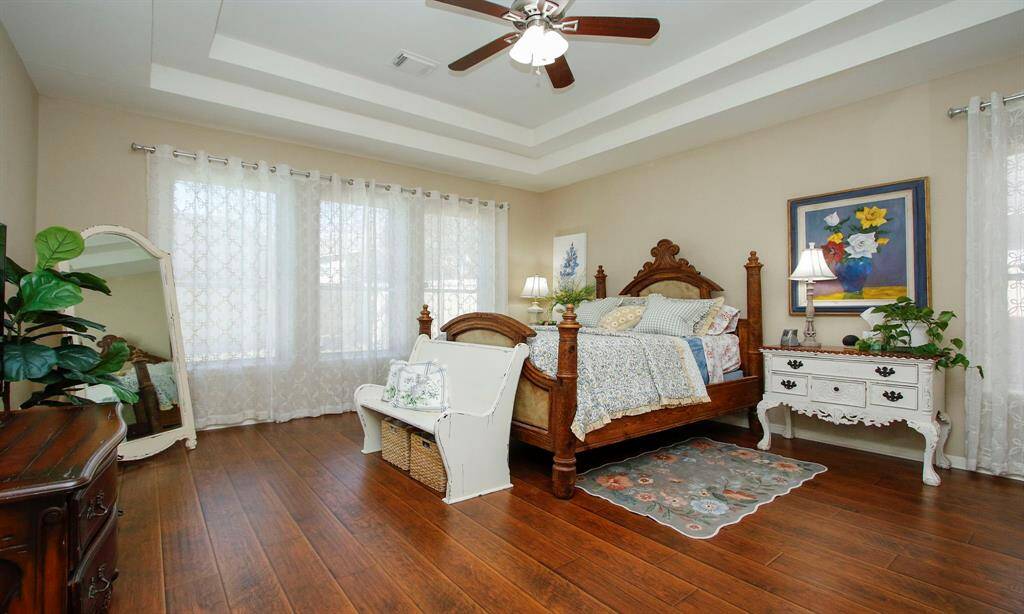 Primary bedroom overlooks backyard oasis.