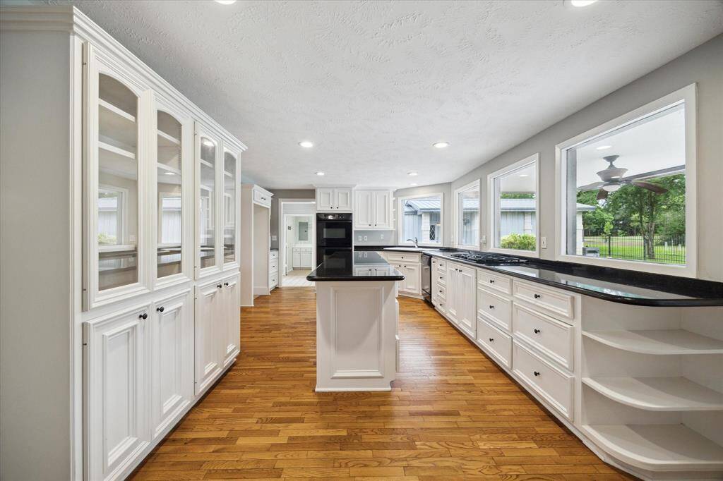Light filled kitchen overlooking pool with built ins and plenty of cabinets.
