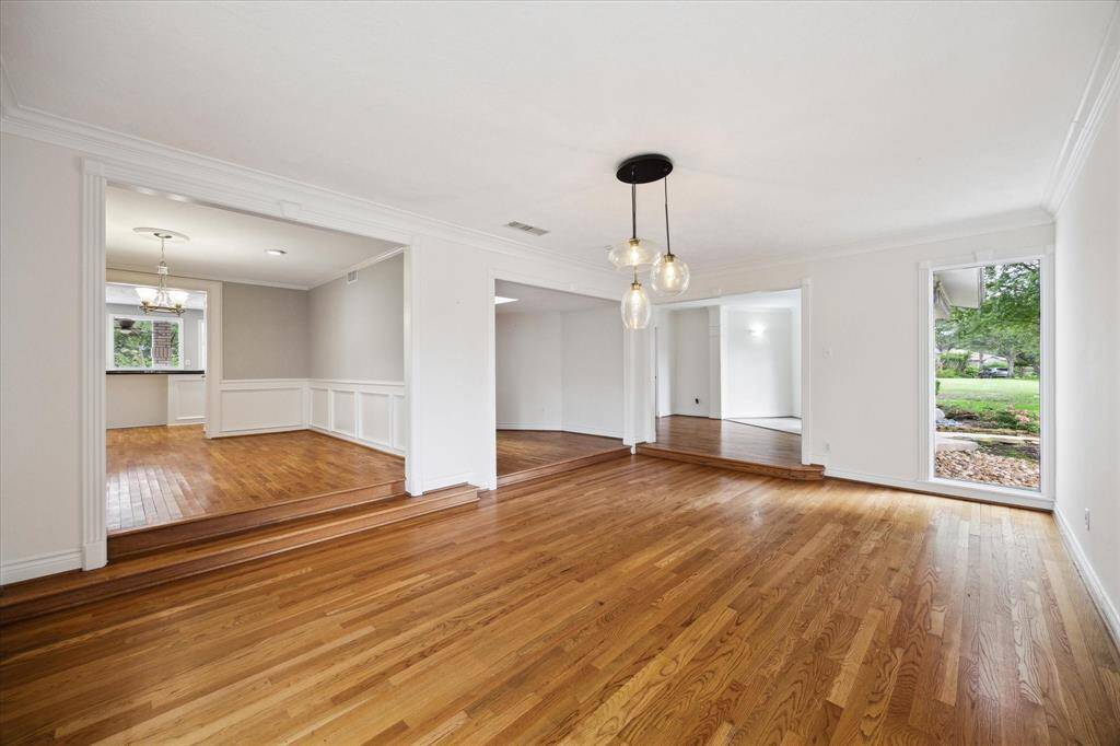 Large front bonus room looking toward entry with formal dining room on the left and then ofiice.