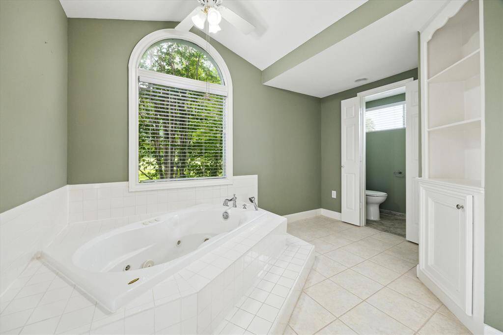 View of tub and water closet.