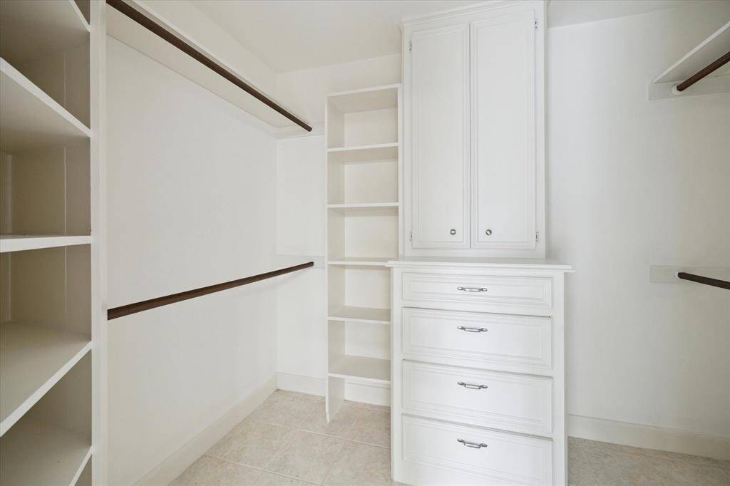 First walk in closet in ensuite with built ins.
