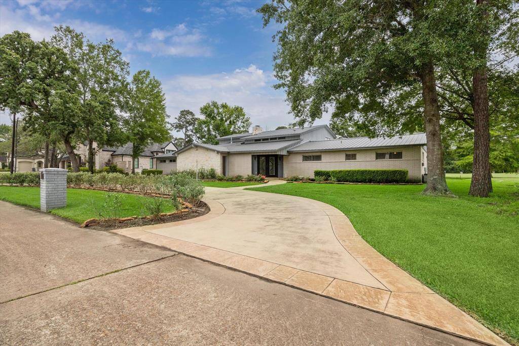 Front view showing circular driveway and sweep of house.