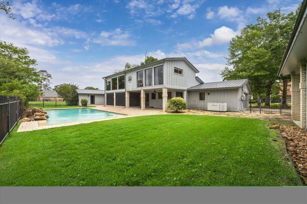 Angle of back shot of house from next to the golf cart garage.