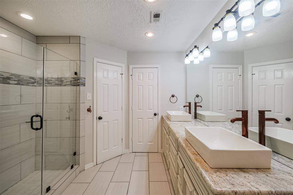 Beautifully updated primary bathroom with duel sinks and oversized shower.