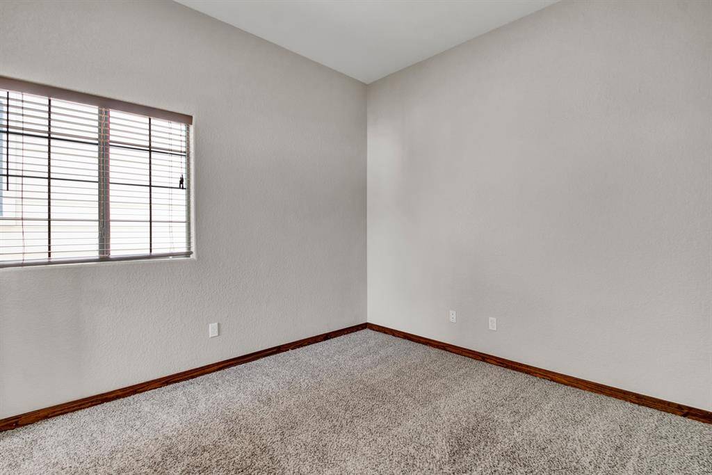 A generously sized secondary bedroom with plush carpet and natural light—perfect as a guest room, nursery, or home office.