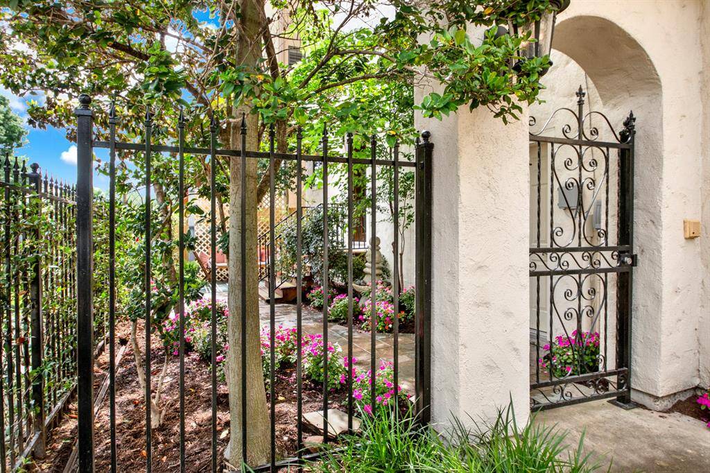 A charming wrought-iron gate welcomes you into a beautifully landscaped front garden, creating a peaceful retreat just beyond the front door.