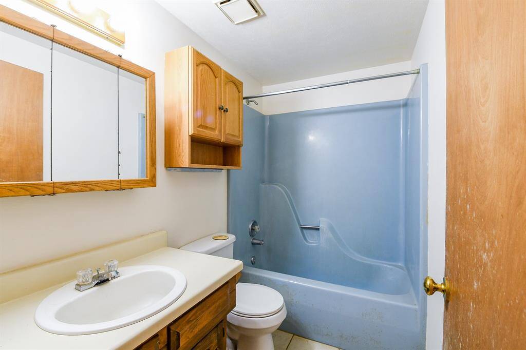 Downstairs full bath situated between the two secondary bedrooms down.
