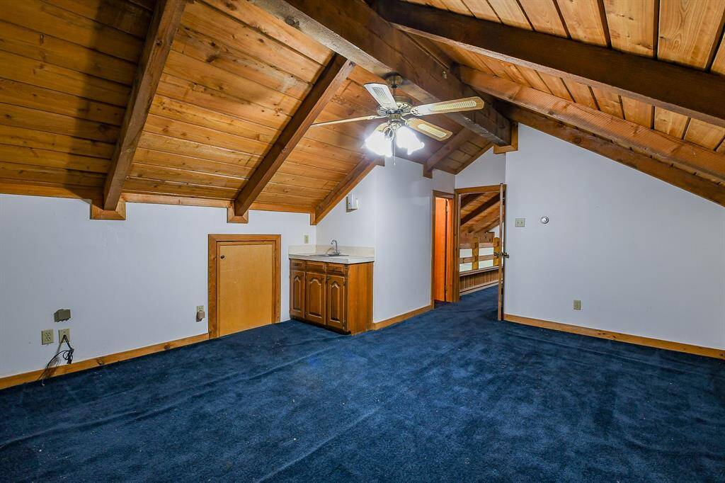 This upstairs bedroom has a half bath and a wet bar in it.