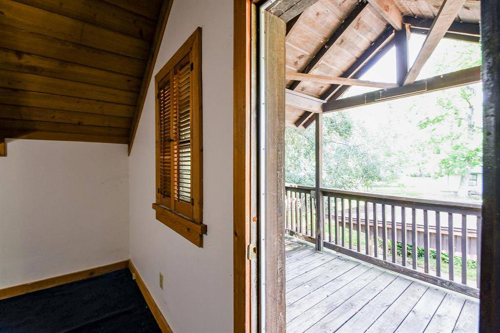 There is a door in this secondary upstairs bedroom that leads to a covered balcony.