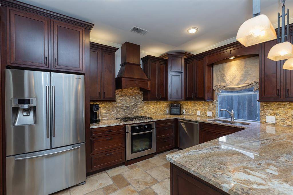 Lovely granite counters, rich cherry finished cabinets, stainless appliances...  It's a joy to work in this space!