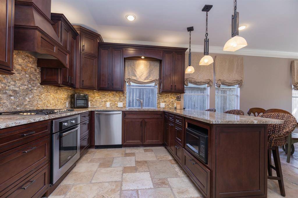 Niche for microwave is under the cabinet to the right.  Look at the beautiful stone flooring, featured throughout the downstairs