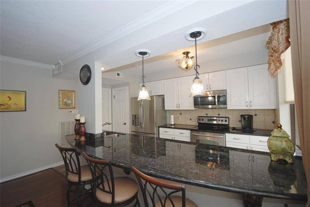 Elegant granite counters with seating for at least 4.