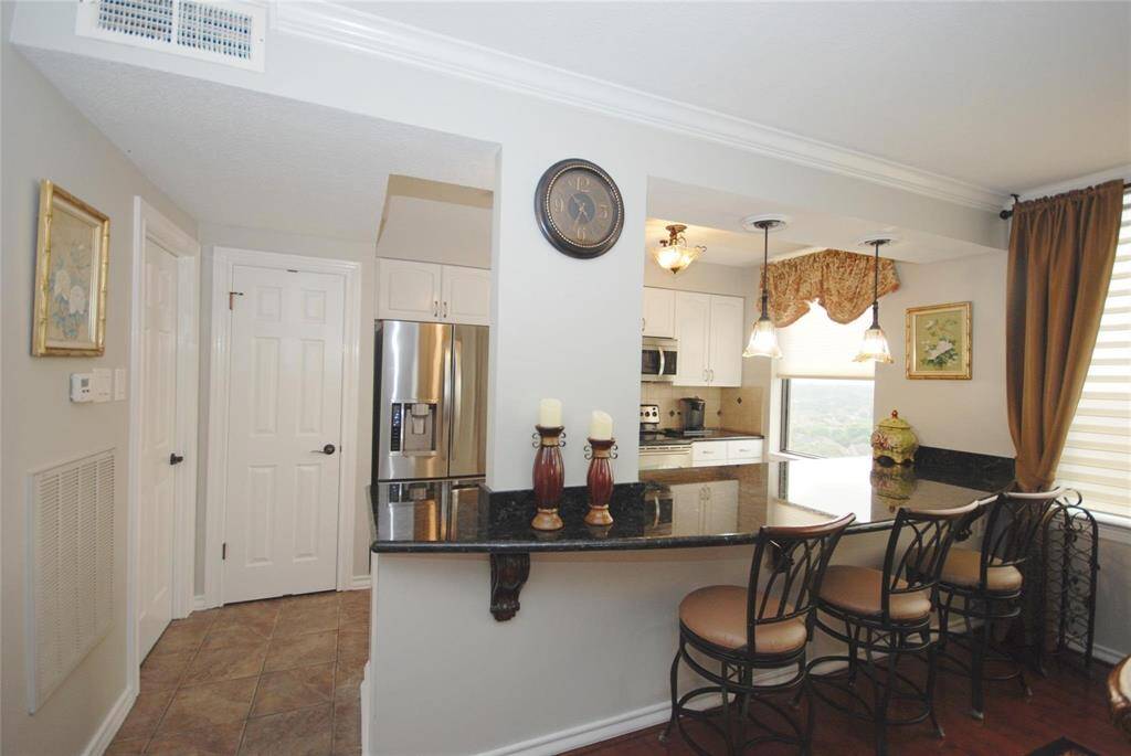 Plenty of cabinets with pantry in view.