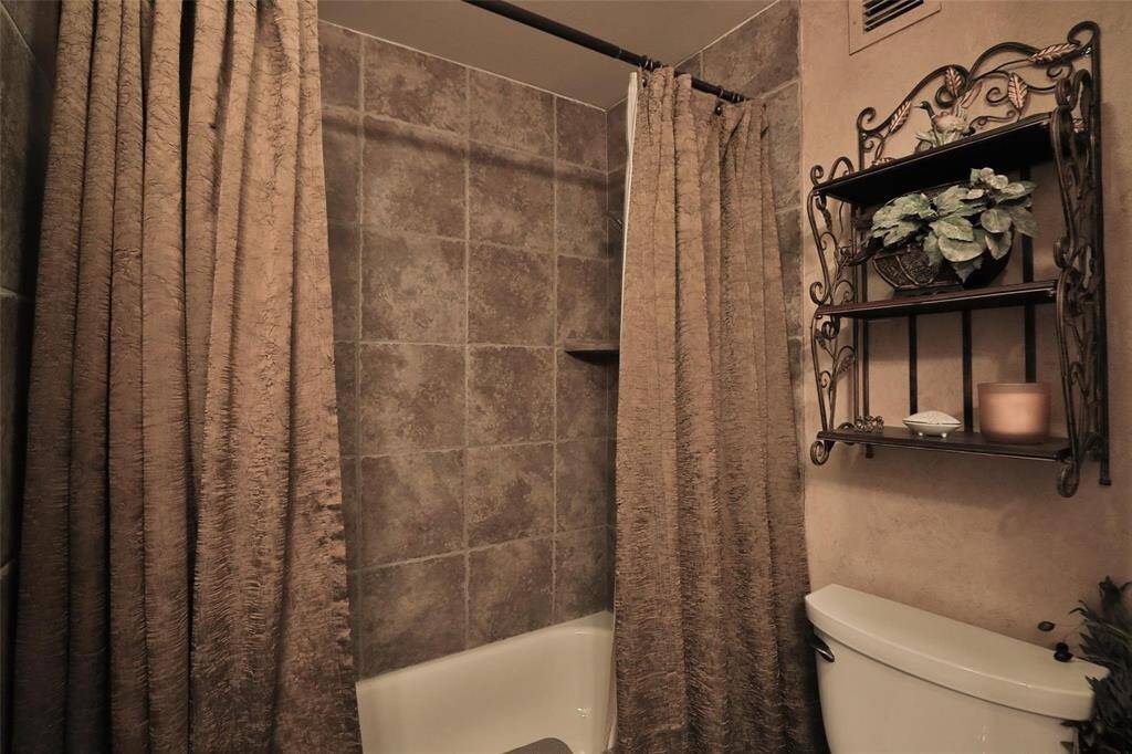 This is a close up of the hall bathroom with sheets and towels.
